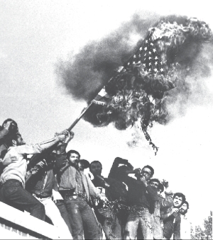 desde los techos del edificio, estudiantes queman bandera yanqui.